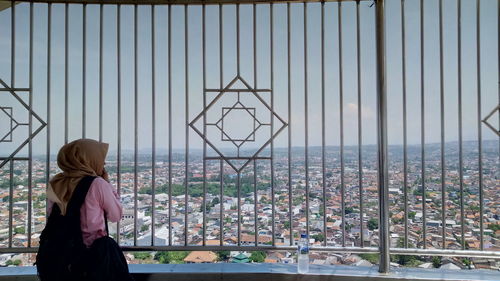 Rear view of woman looking at cityscape