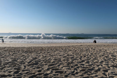 Scenic view of beach against clear sky