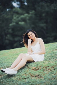 Young woman sitting on a land