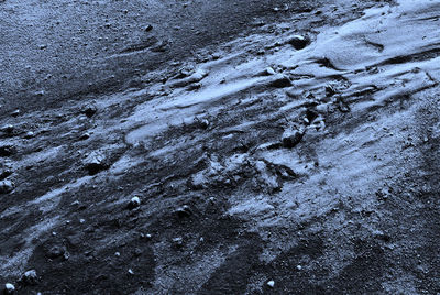 High angle view of footprints on wet sand