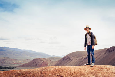 Man standing on mountain against sky