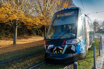 Train on railroad track amidst trees against sky