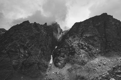 Low angle view of rock formations against sky