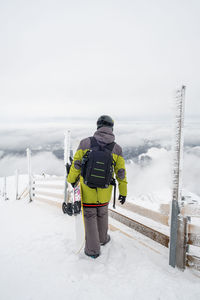 People skiing on snow covered landscape