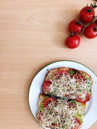 High angle view of cherry tomatoes in plate on table