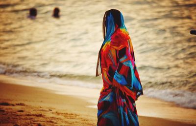 Side view of woman walking at beach