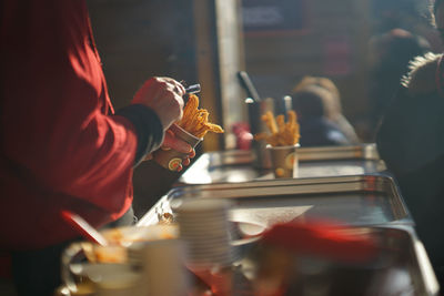 Close-up of person serving food