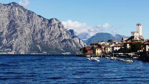 Scenic view of sea and mountains against clear sky