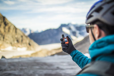 Climber uses a gps to navigate in a high mountain pass.