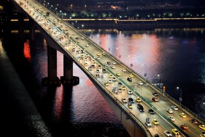 High angle view of illuminated bridge over river at night