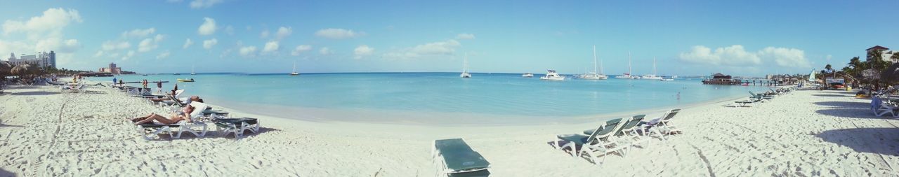 Scenic view of beach against cloudy sky