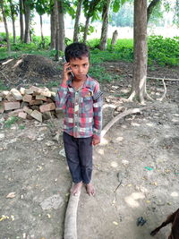 Portrait of boy standing on ground