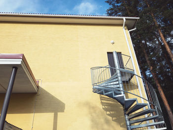 Low angle view of metal 
staircase against building