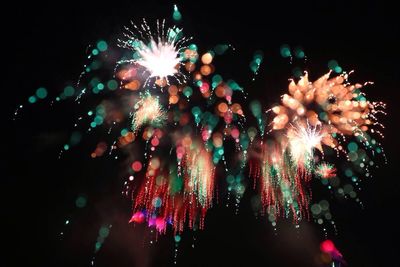 Low angle view of firework display at night