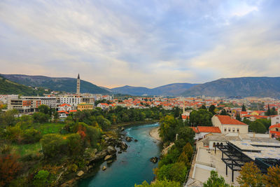 High angle view of river and townscape against sky