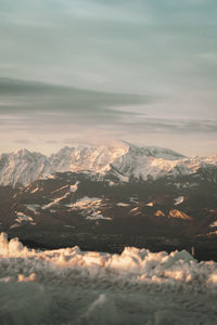 Aerial view of snowcapped mountains against sky