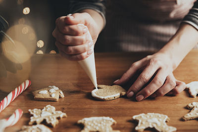Christmas, new year food preparation. xmas gingerbread cooking, making and decorating baked cookies