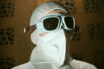 Portrait of man wearing protective goggles in laboratory