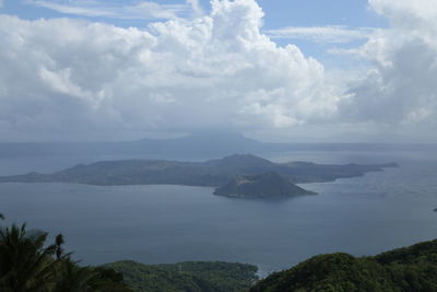 Scenic view of sea and mountains against sky