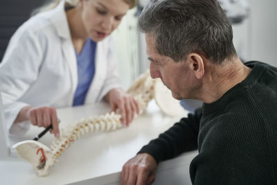 Side view of doctor examining patient