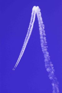 Aerial view of vapor trail against blue sky