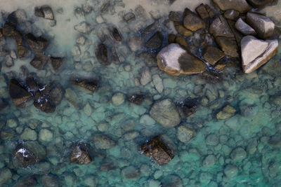 Full frame shot of pebbles in sea