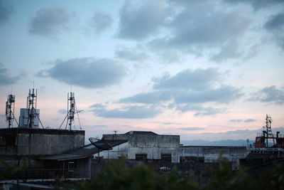 Buildings in city against sky during sunset