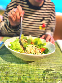 Midsection of man sitting on table