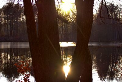 Scenic view of lake against sky at sunset