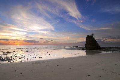 Scenic view of beach against sky during sunset