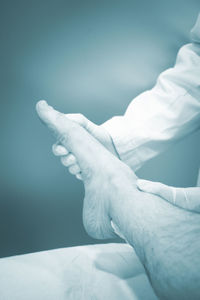 Cropped hands of doctor examining patient 