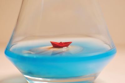 Close-up of drink in glass against blue background