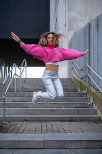 Portrait of young woman sitting on staircase