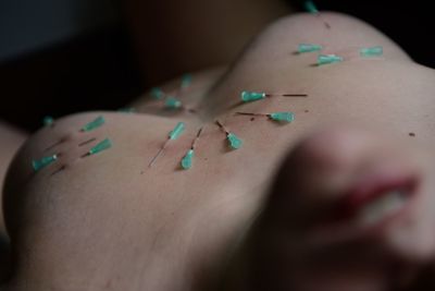 Close-up of woman lying on hand