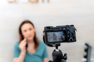 Portrait of woman photographing camera