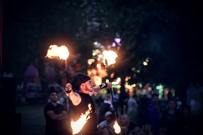 People enjoying music concert at night