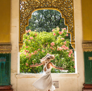 Woman standing by plants