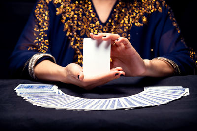 Fortune teller's hands and tarot cards. free copy space on card.