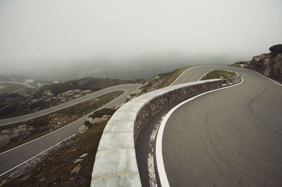 Aerial view of mountain road in foggy weather