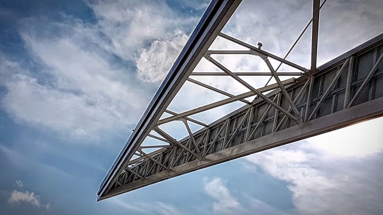 cloud - sky, low angle view, sky, architecture, built structure, connection, nature, metal, bridge, day, no people, transportation, bridge - man made structure, outdoors, building exterior, city, alloy