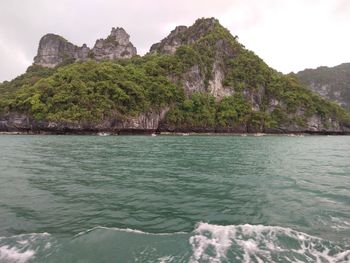 Scenic view of sea and mountains against sky