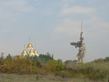 Low angle view of temple against cloudy sky