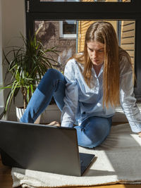 Online training. work at home at the computer. girl freelancer working on a laptop. 