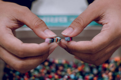 Cropped hands holding plastic blocks