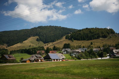 Houses on field against sky