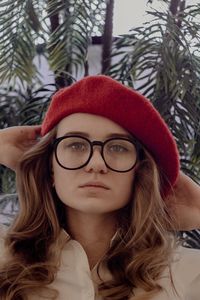 Close-up portrait of young woman wearing flat cap