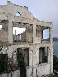 Low angle view of damaged building against clear sky