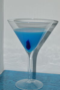Close-up of drink on blue glass
