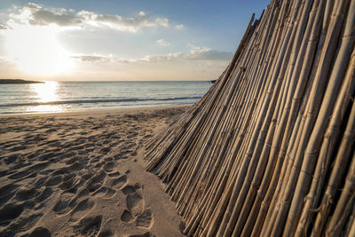 Scenic view of beach against sky during sunset