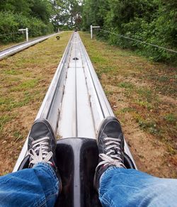 Low section of man sitting on bobsled